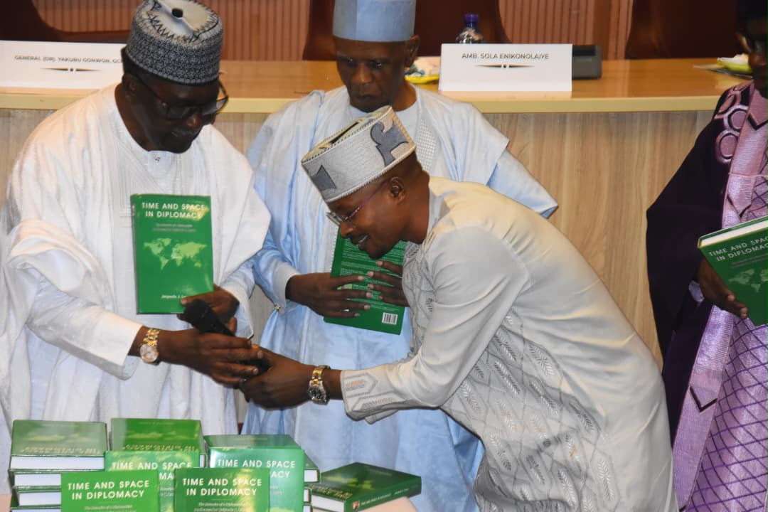 Rep. Abejide in a Handshake with Ambassador Jaiyeola Lewu